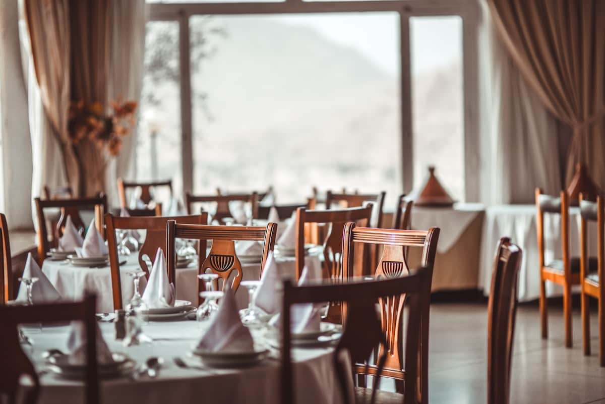 Evening restaurant dining room with set tables